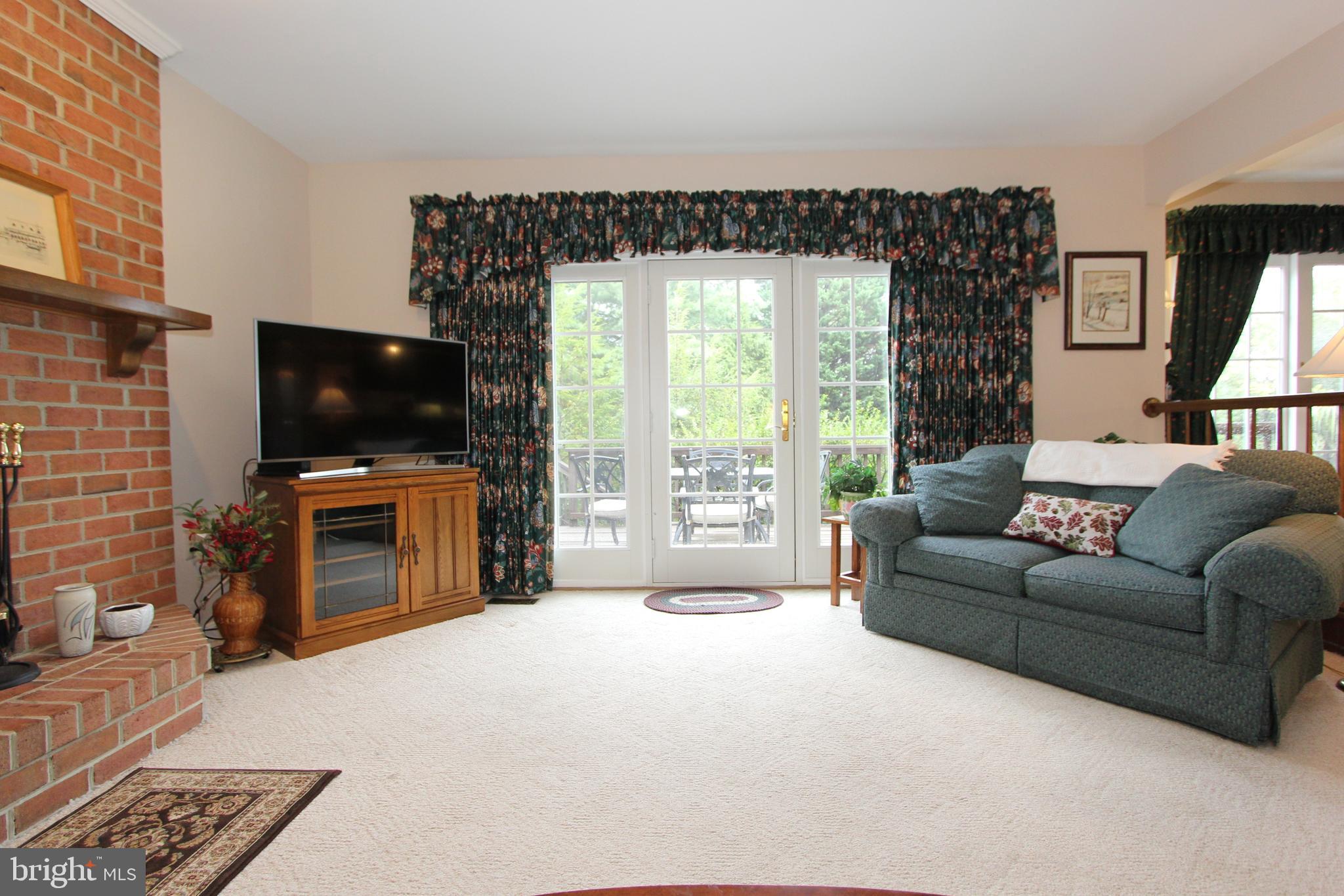 6670 Springhill Drive Frederick, MD 21702 - Photo 22 of 98 a living room with furniture and a flat screen tv