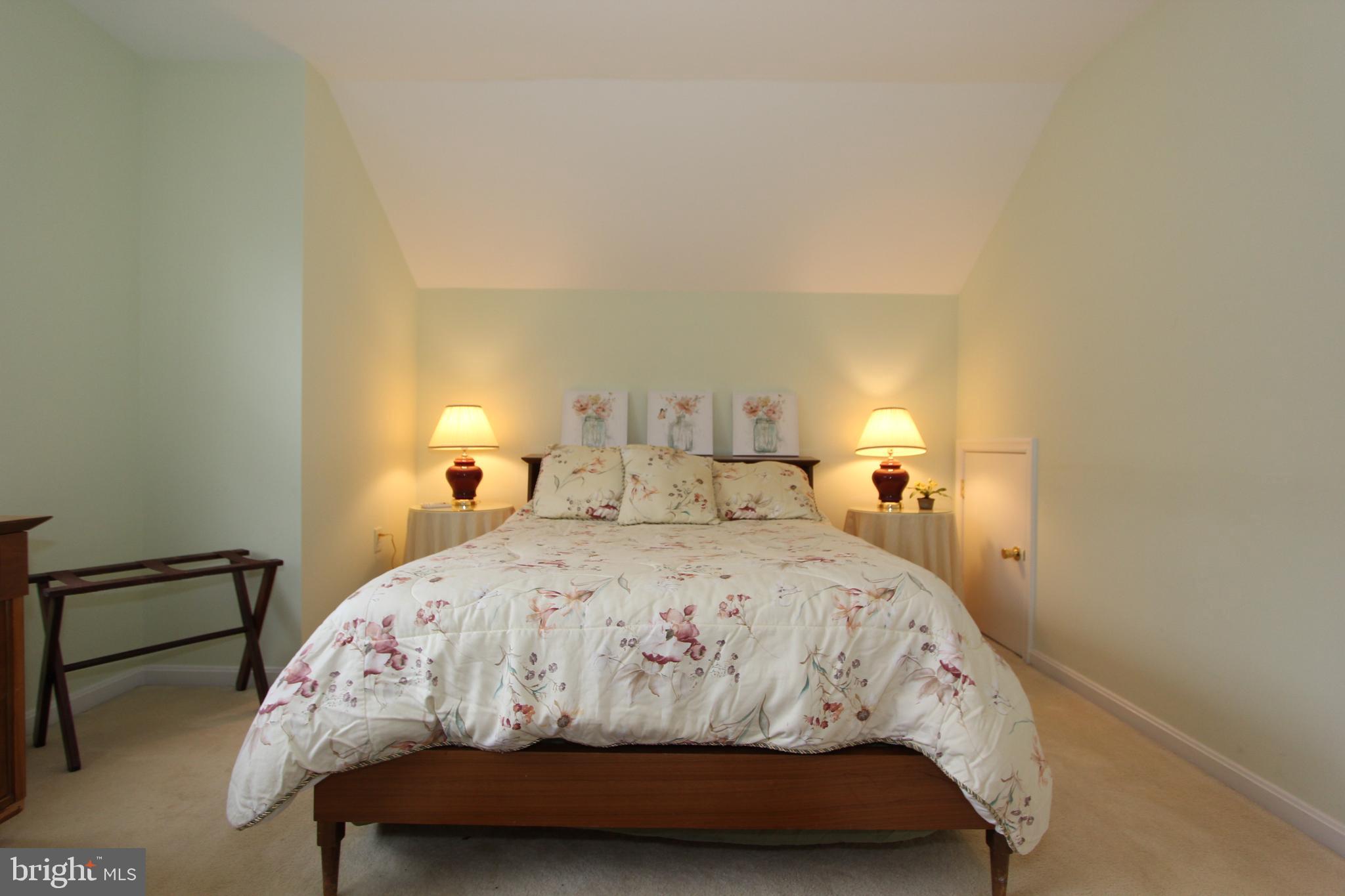 6670 Springhill Drive Frederick, MD 21702 - Photo 43 of 98 a bedroom with a bed and a lamp with the wall