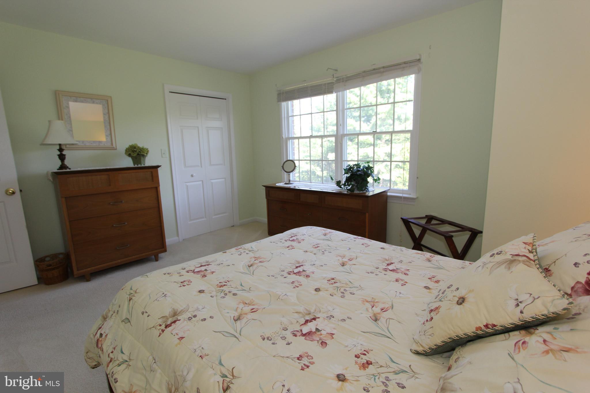 6670 Springhill Drive Frederick, MD 21702 - Photo 45 of 98 a bedroom with a bed and dresser with mirror