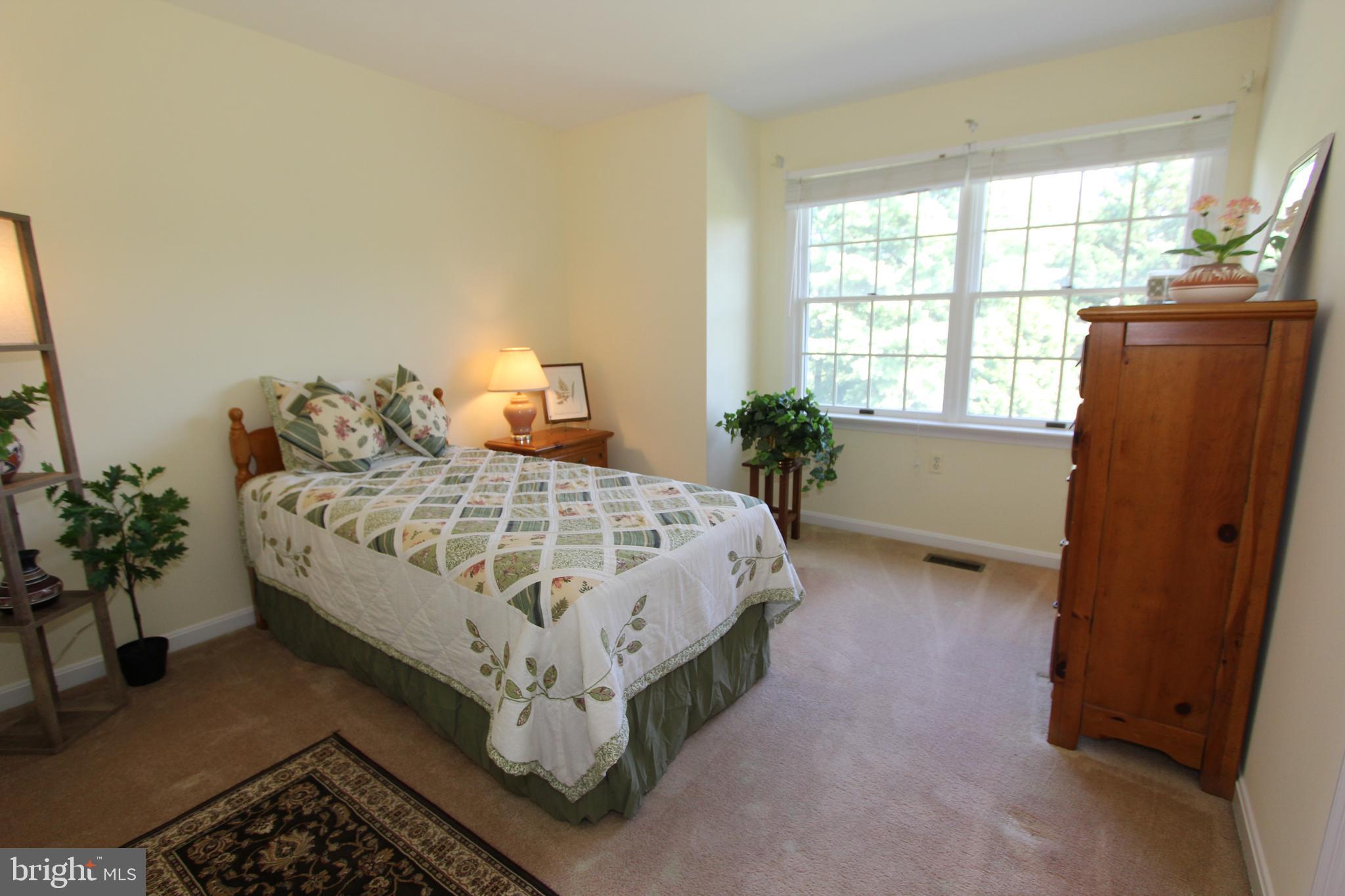 6670 Springhill Drive Frederick, MD 21702 - Photo 48 of 98 a bed sitting in a bedroom next to a window