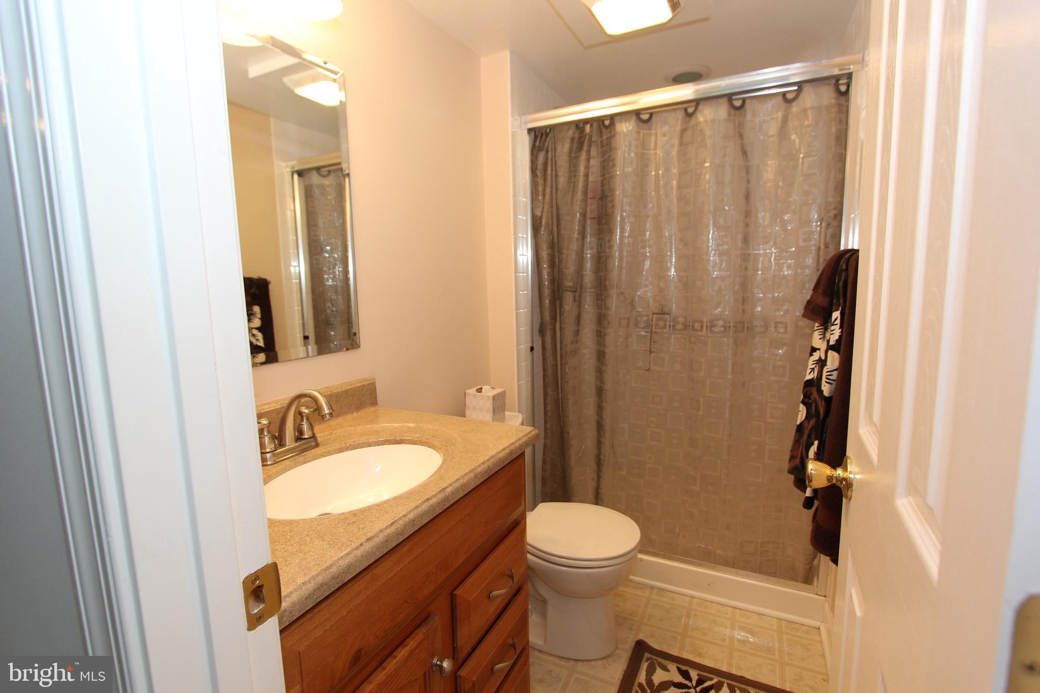 6670 Springhill Drive Frederick, MD 21702 - Photo 55 of 98 a bathroom with a granite countertop sink toilet and shower