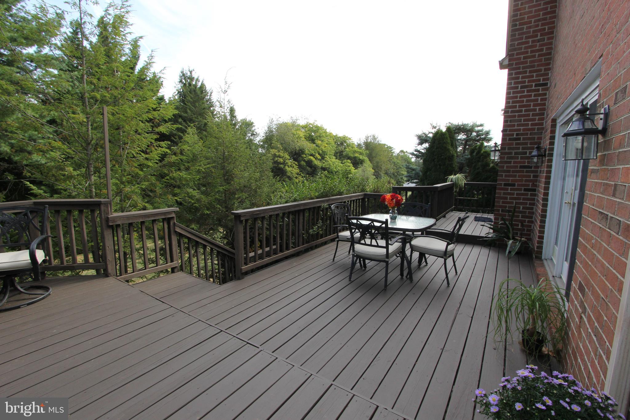 6670 Springhill Drive Frederick, MD 21702 - Photo 60 of 98 a view of a roof deck with table and chairs and wooden floor