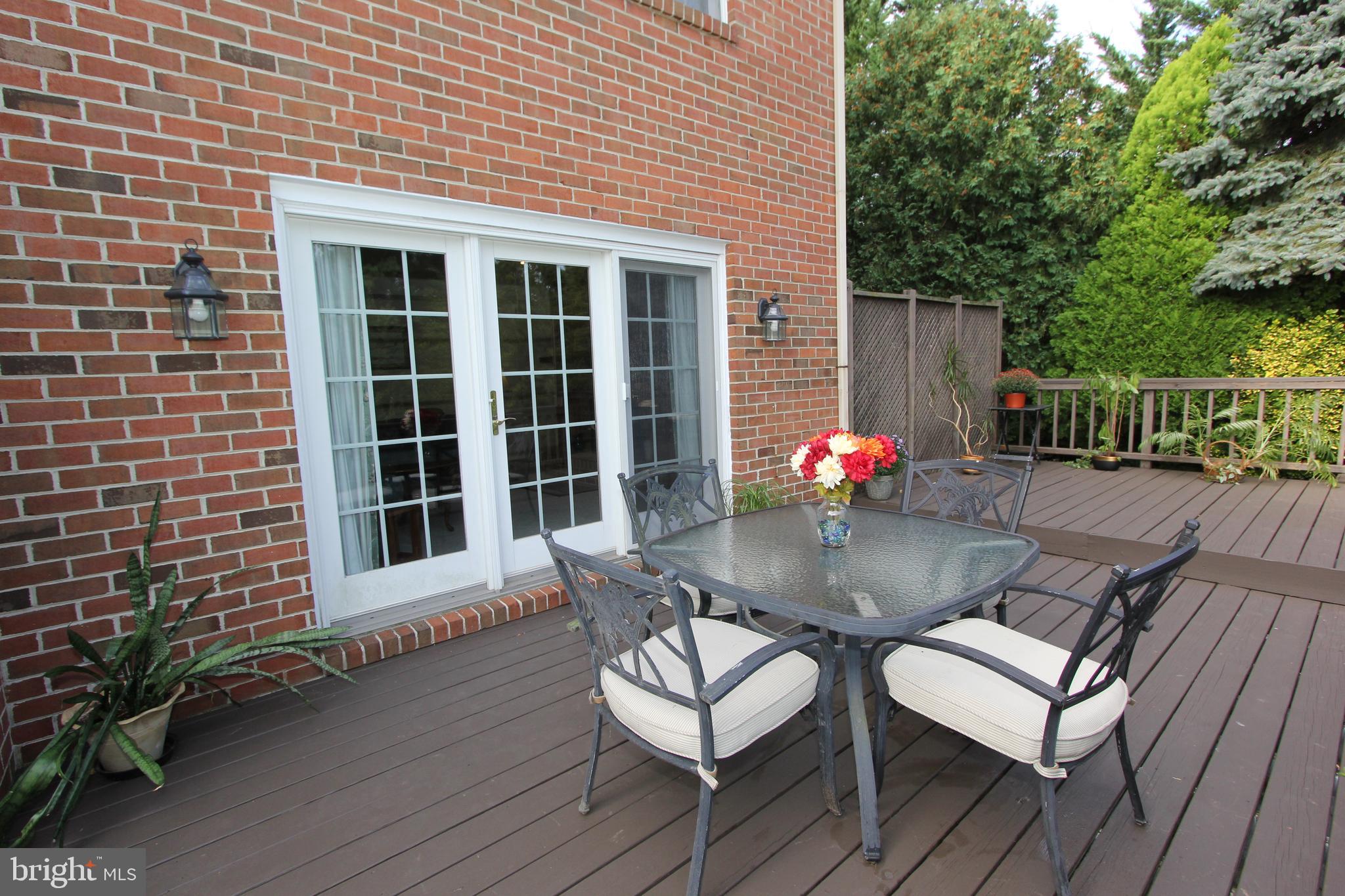 6670 Springhill Drive Frederick, MD 21702 - Photo 63 of 98 a backyard of a house with wooden floor chairs sofa and barbecue oven