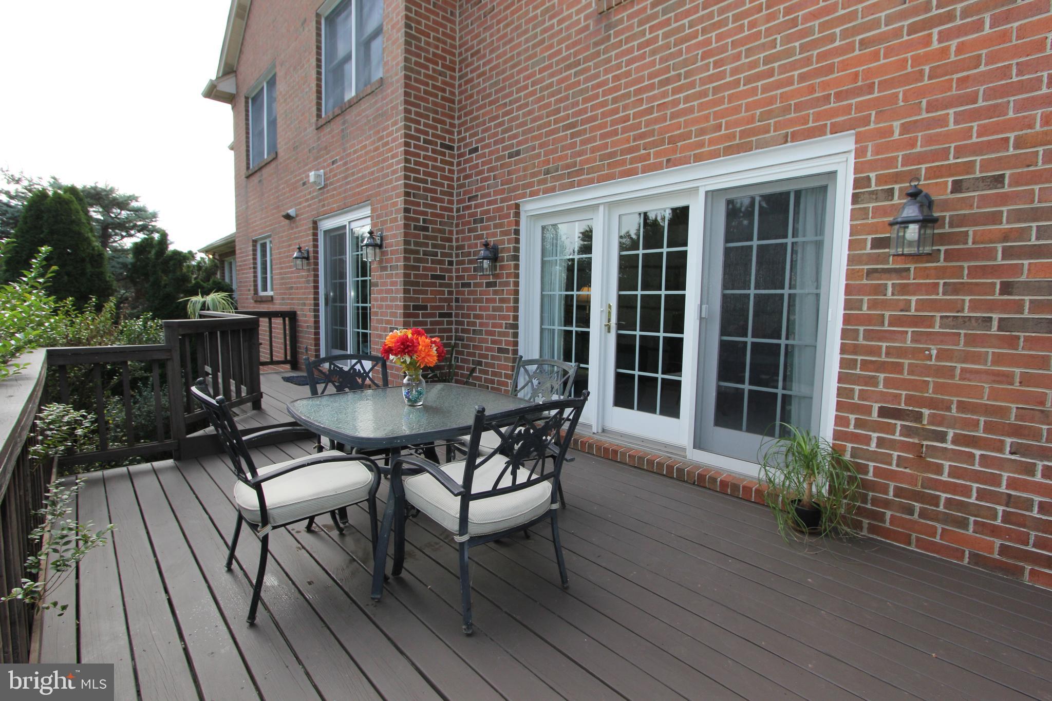 6670 Springhill Drive Frederick, MD 21702 - Photo 65 of 98 a view of a patio with table and chairs and wooden floor