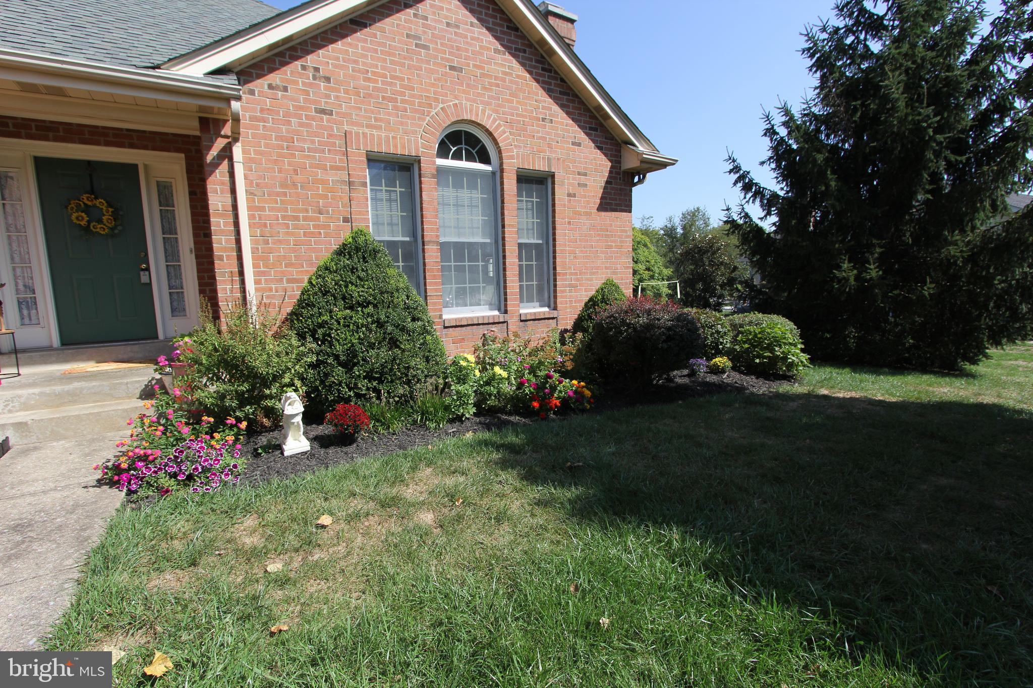 6670 Springhill Drive Frederick, MD 21702 - Photo 76 of 98 a front view of a house with a garden