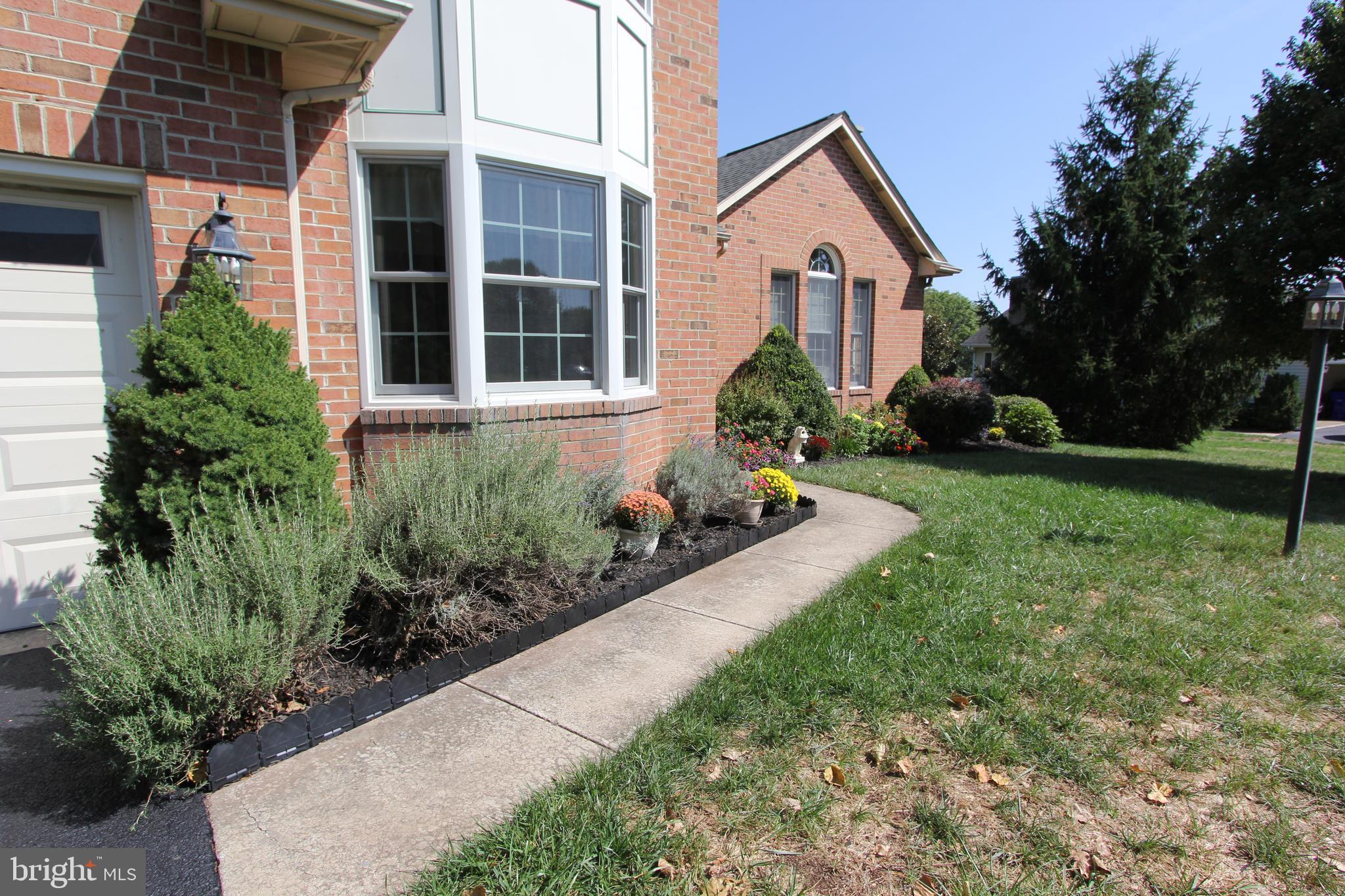 6670 Springhill Drive Frederick, MD 21702 - Photo 77 of 98 a front view of a house with garden