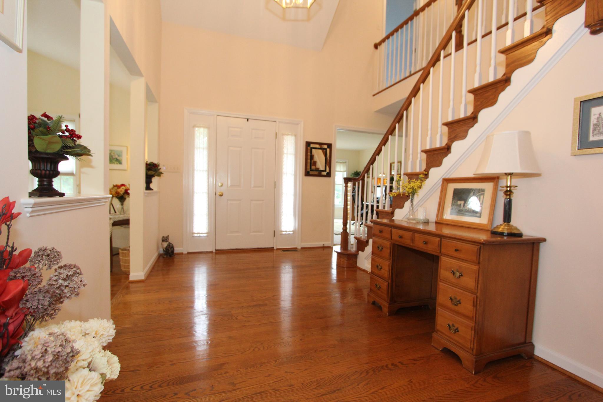 6670 Springhill Drive Frederick, MD 21702 - Photo 10 of 98 a view of entryway with wooden floor and stairs