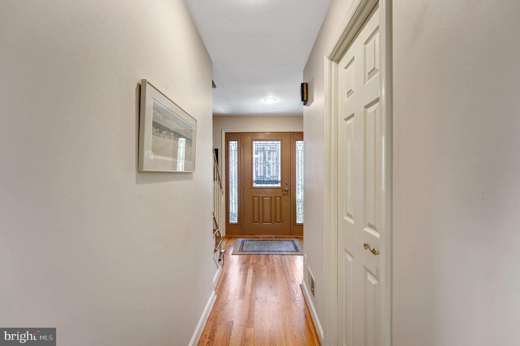 60 East Clearfield Road Havertown, PA 19083 - Photo 14 of 57 a view of a hallway with wooden floor and a bathroom
