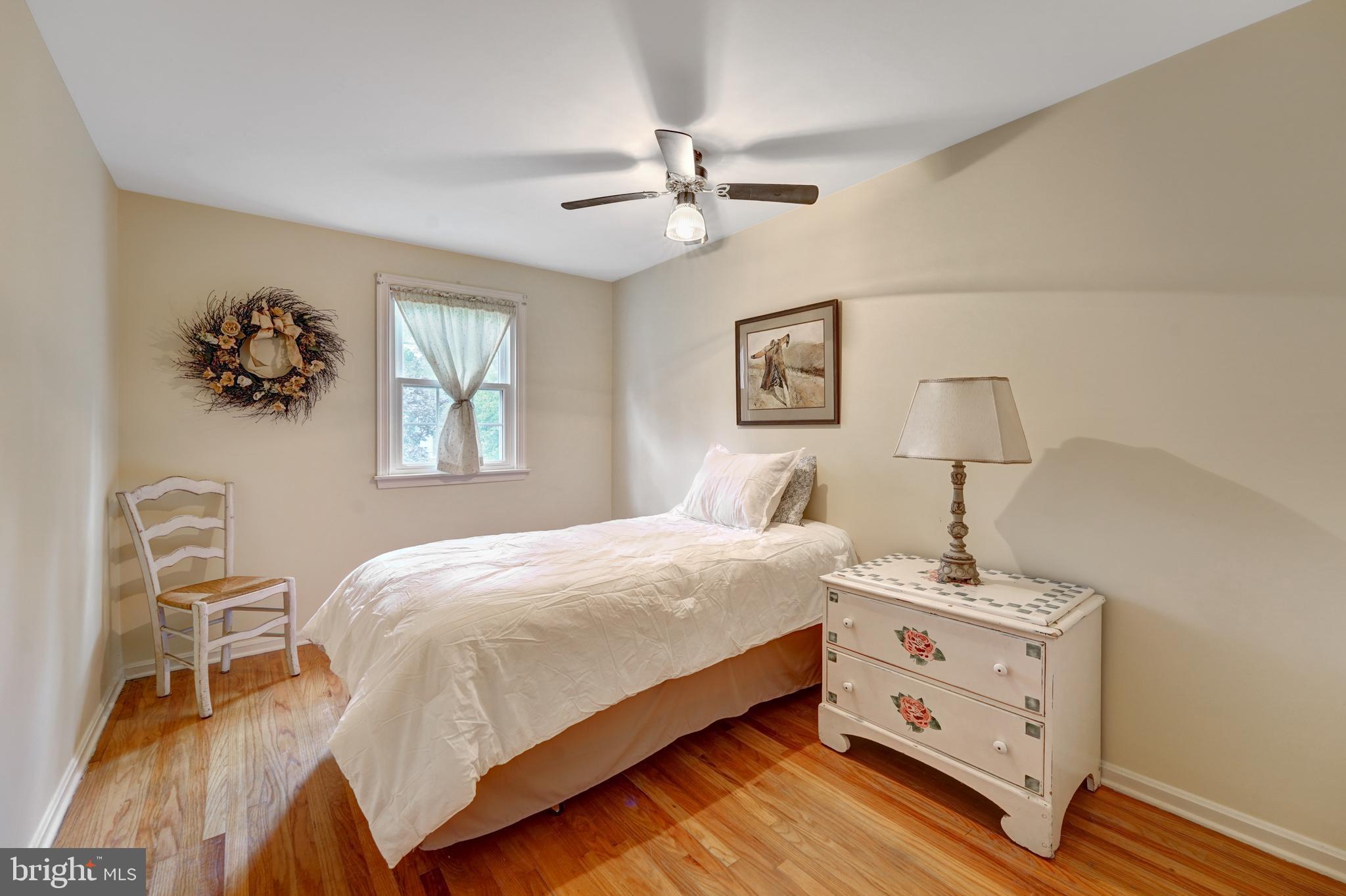 60 East Clearfield Road Havertown, PA 19083 - Photo 25 of 57 a bedroom with a bed and a chandelier