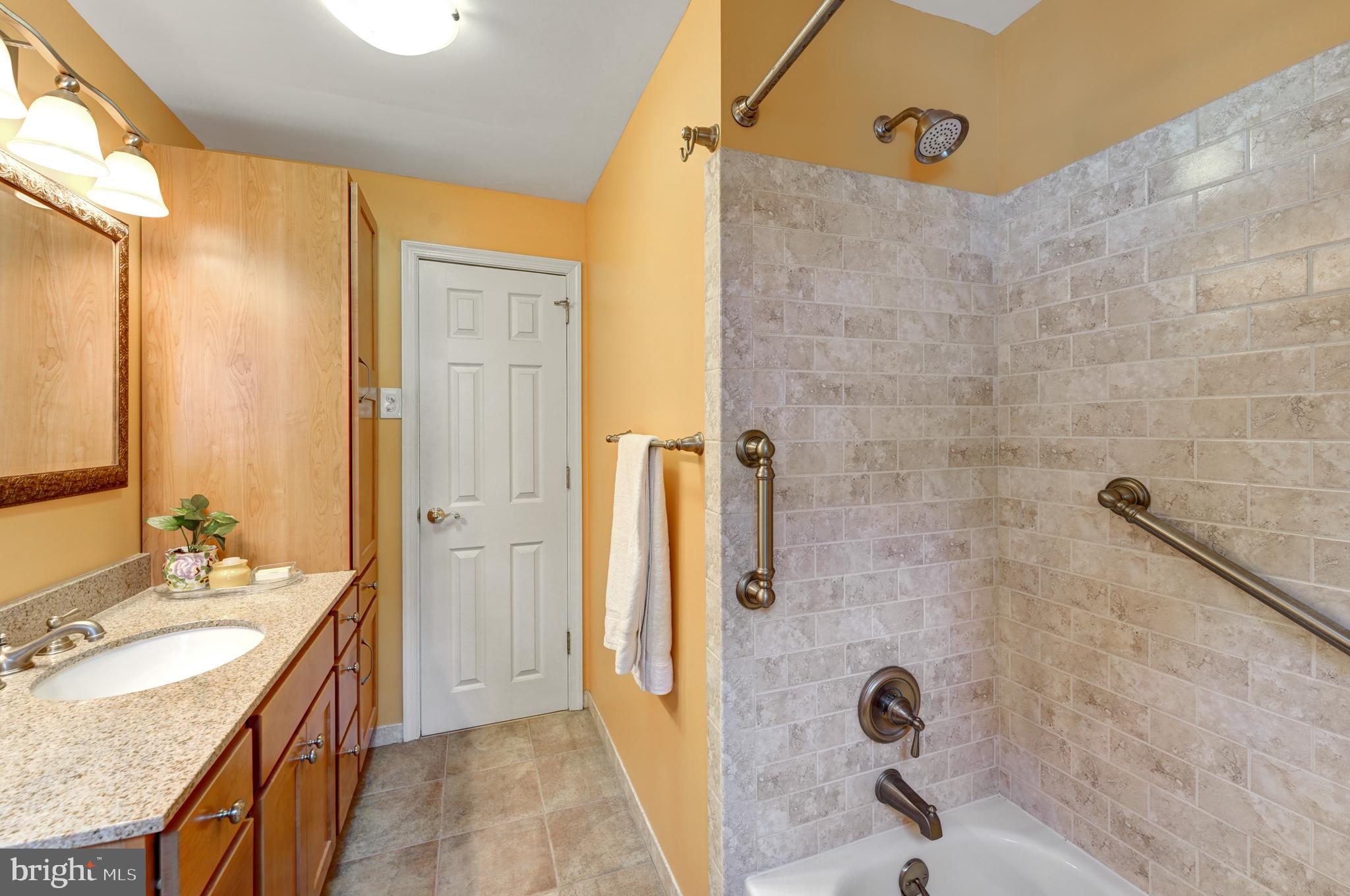 60 East Clearfield Road Havertown, PA 19083 - Photo 27 of 57 a bathroom with a granite countertop sink a mirror and shower
