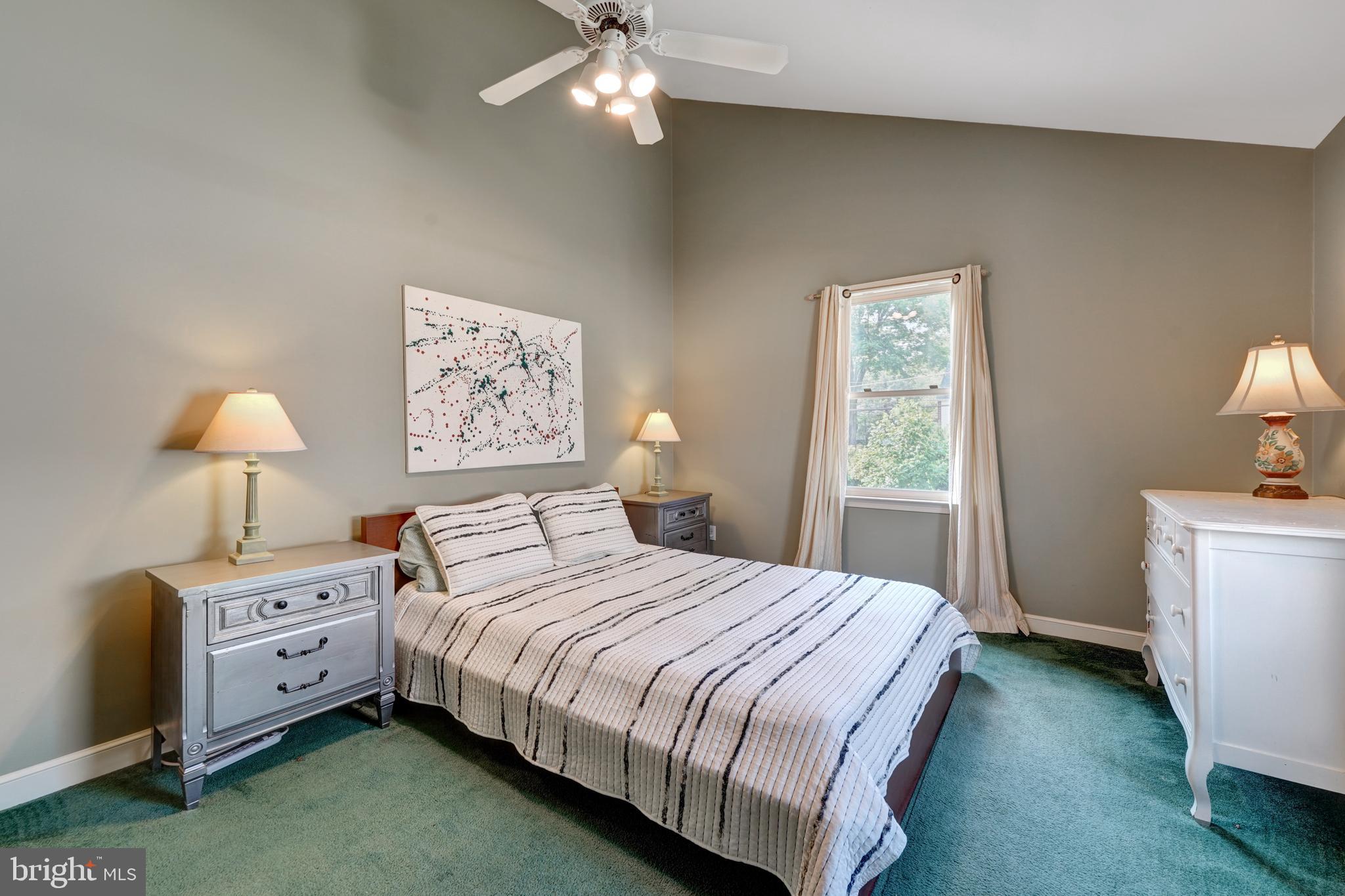 60 East Clearfield Road Havertown, PA 19083 - Photo 31 of 57 a bedroom with a bed and a lamp on dresser