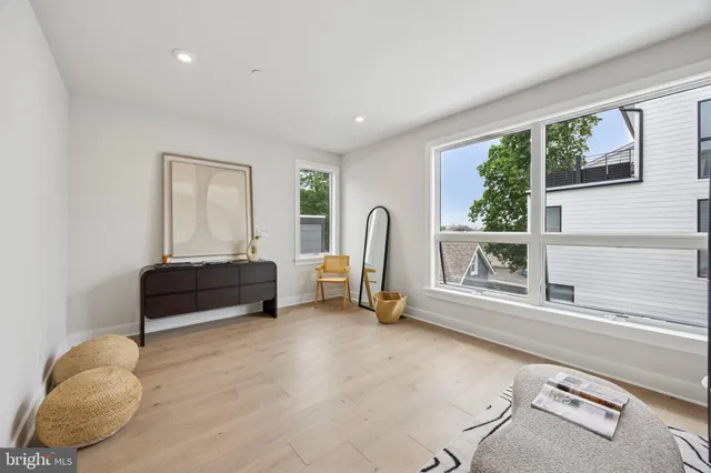 a bedroom with furniture and a large window
