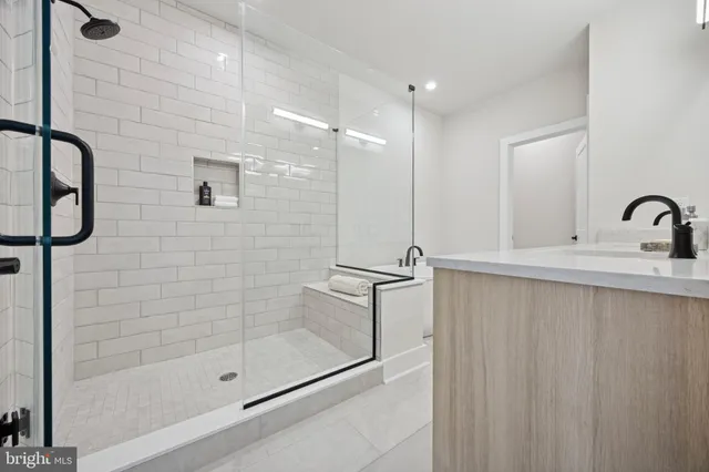 a bathroom with a shower sink and mirror