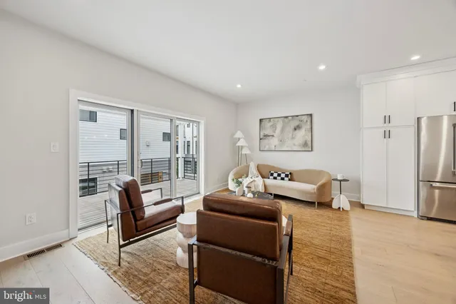a living room with furniture and a floor to ceiling window
