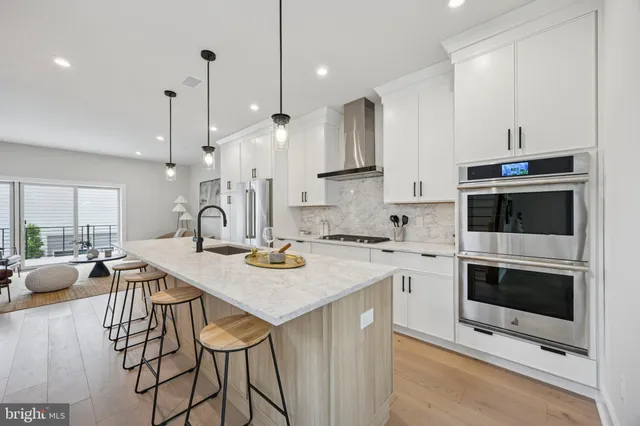 a kitchen with a stove a sink and a refrigerator