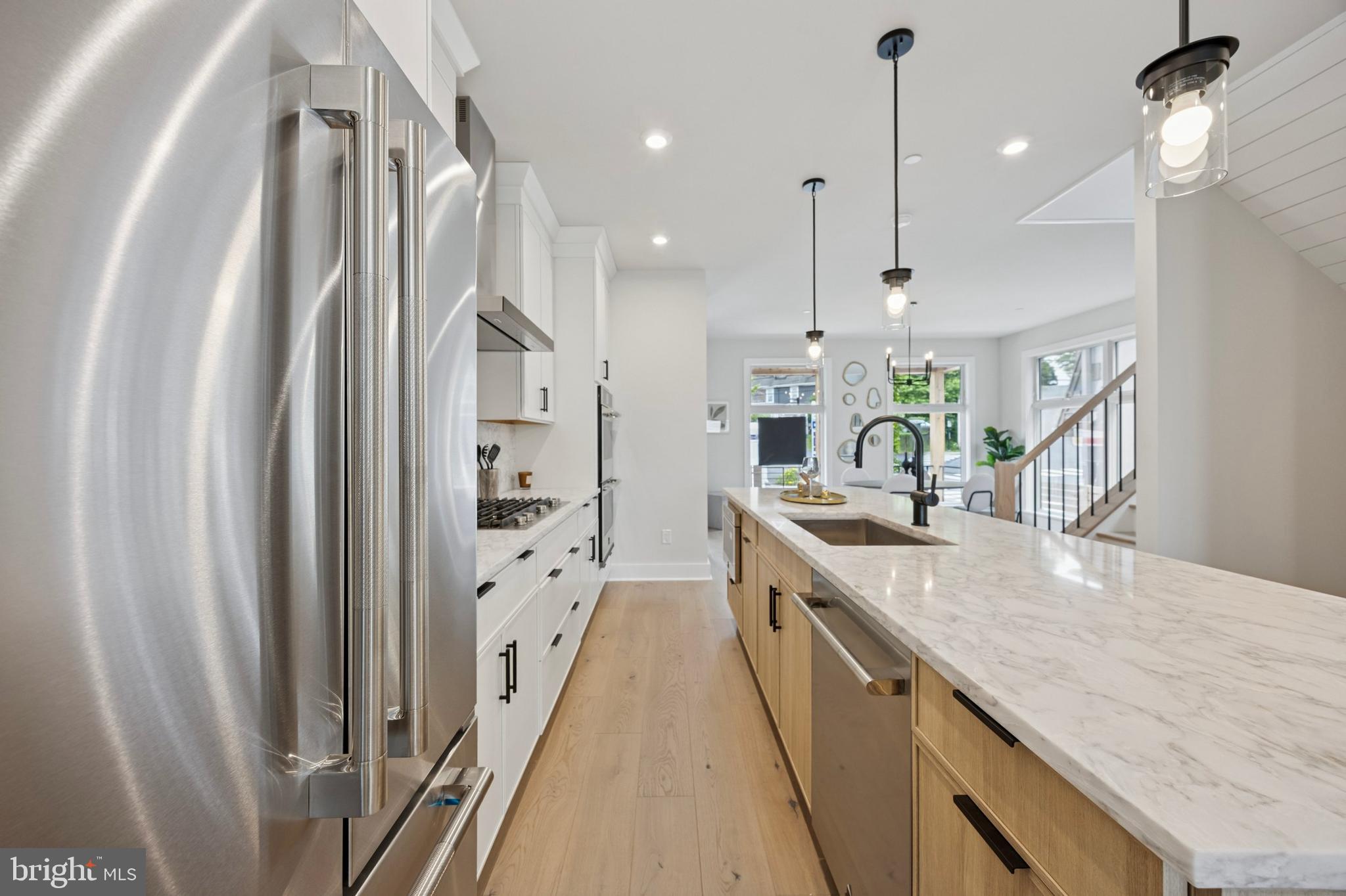 226 North Main Street Doylestown, PA 18901 - Photo 10 of 24 a large kitchen with granite countertop a large kitchen island white cabinetry and stainless steel appliances
