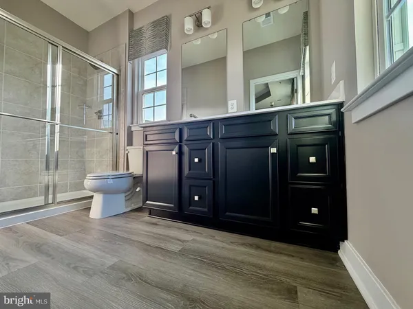 a kitchen with stainless steel appliances kitchen island granite countertop a refrigerator and a stove top oven