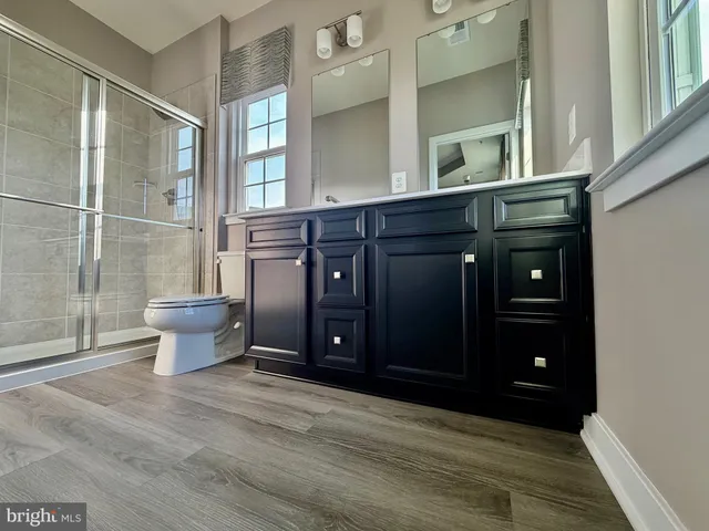 a kitchen with stainless steel appliances kitchen island granite countertop a refrigerator and a stove top oven