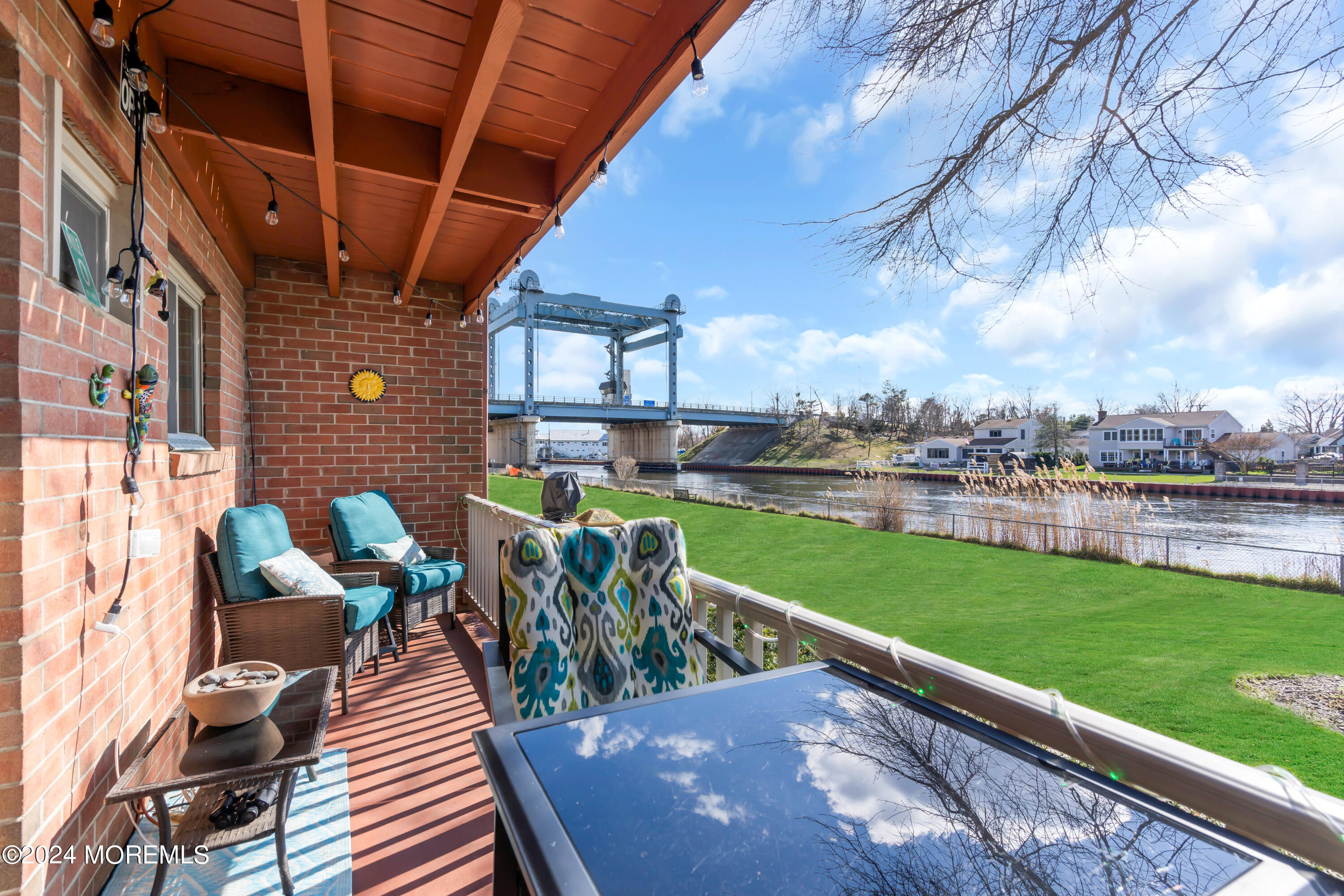 1641 Elm Avenue, Unit 18 Point Pleasant, NJ 08742 - Photo 18 of 23 a view of a patio with table and chairs with wooden floor and fence