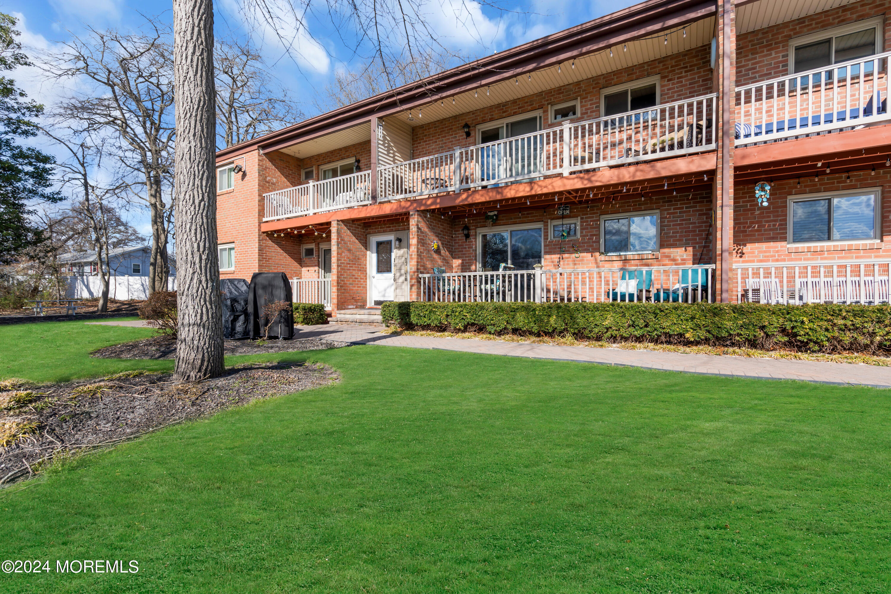 1641 Elm Avenue, Unit 18 Point Pleasant, NJ 08742 - Photo 21 of 23 a front view of a building with a garden