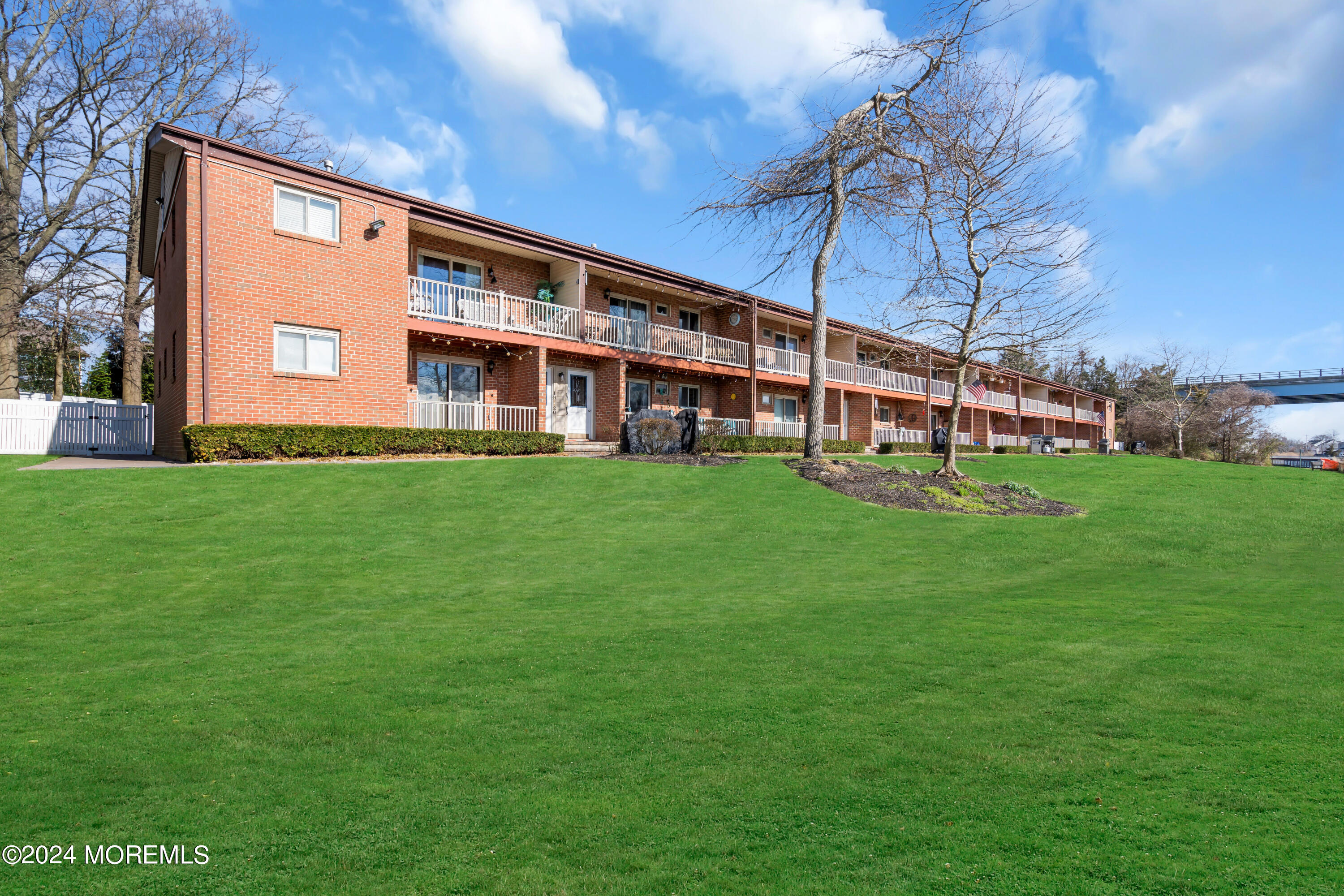 1641 Elm Avenue, Unit 18 Point Pleasant, NJ 08742 - Photo 22 of 23 a large building with a big yard