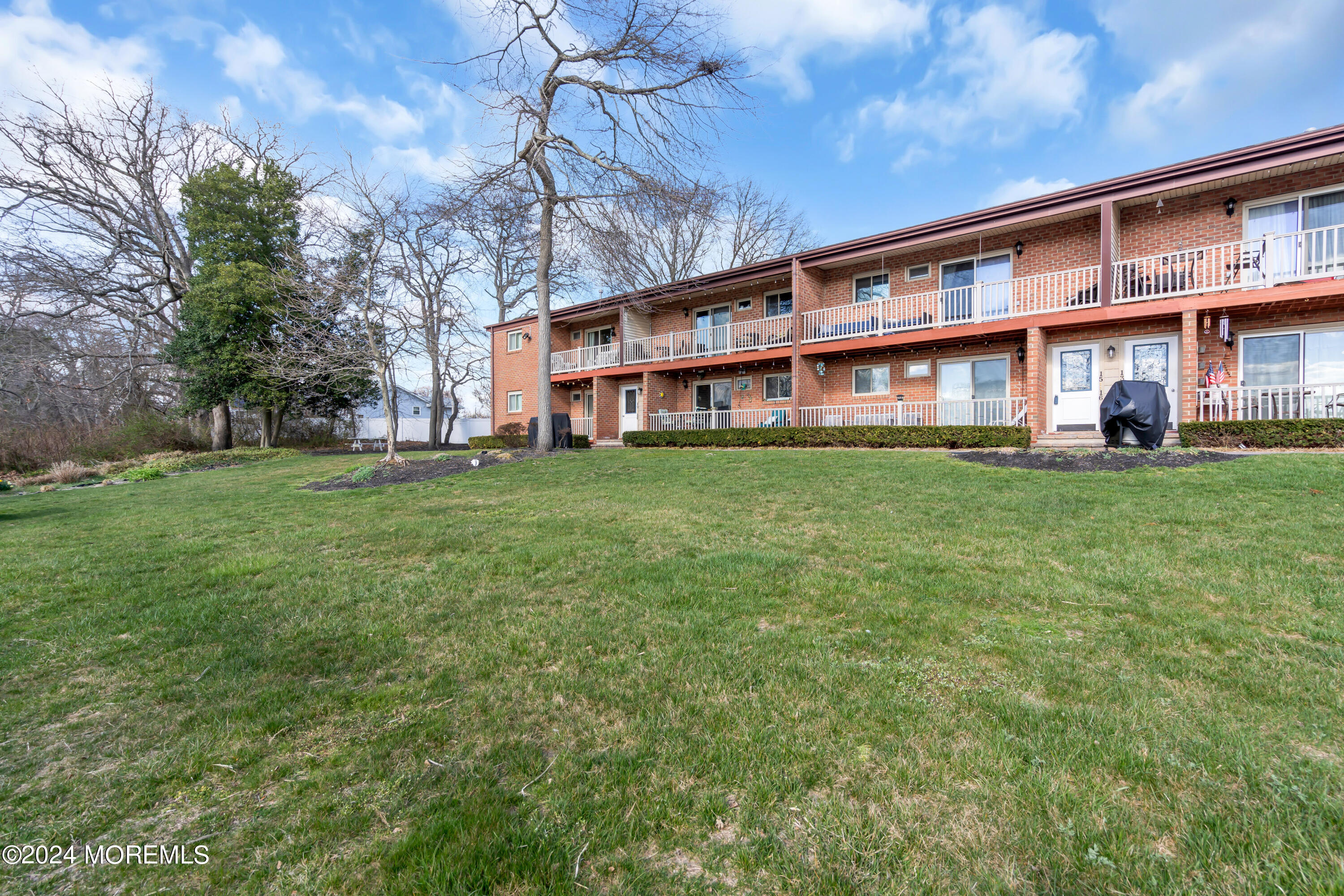 1641 Elm Avenue, Unit 18 Point Pleasant, NJ 08742 - Photo 23 of 23 a view of a building with a yard