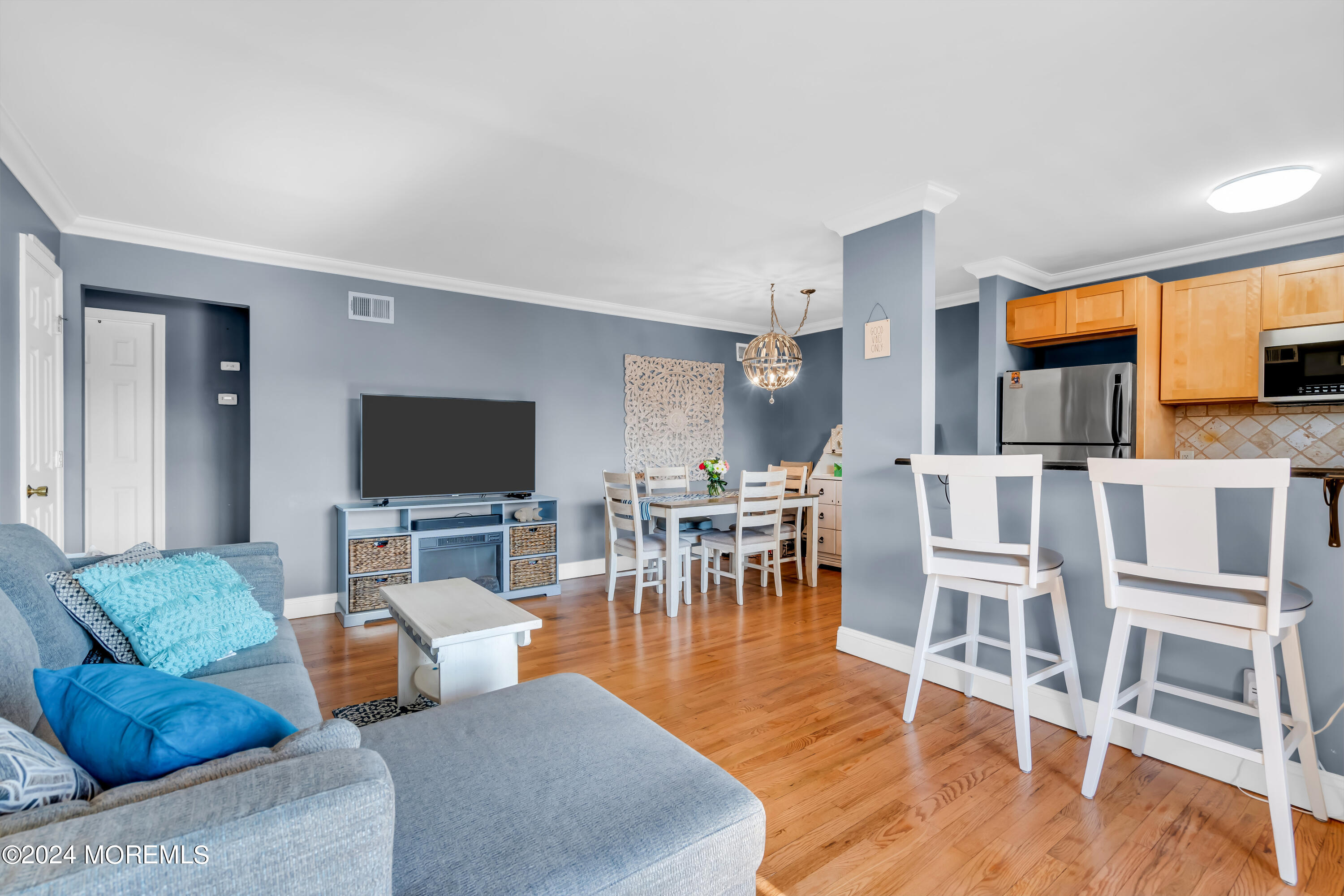 1641 Elm Avenue, Unit 18 Point Pleasant, NJ 08742 - Photo 4 of 23 a living room with furniture a flat screen tv and kitchen view