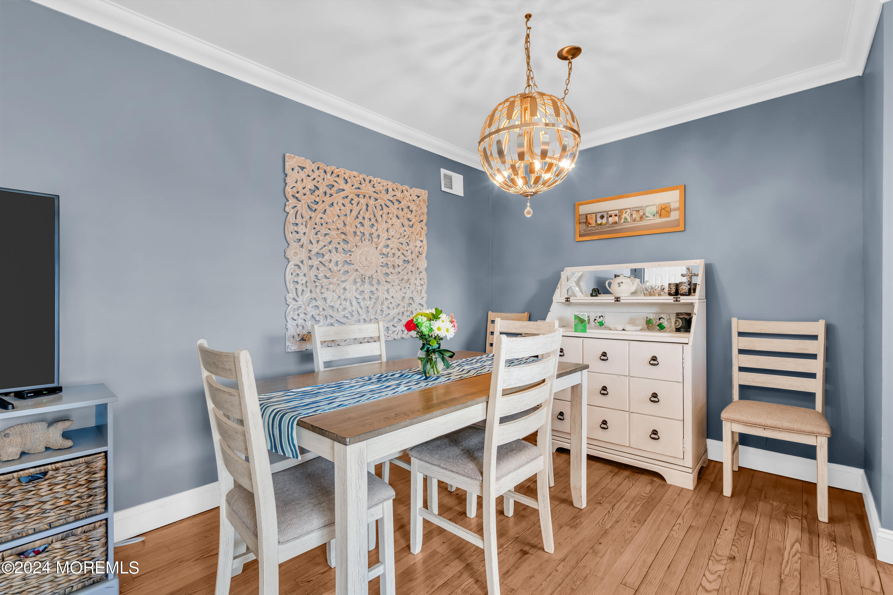 1641 Elm Avenue, Unit 18 Point Pleasant, NJ 08742 - Photo 7 of 23 a view of a dining room with furniture wooden floor and a chandelier
