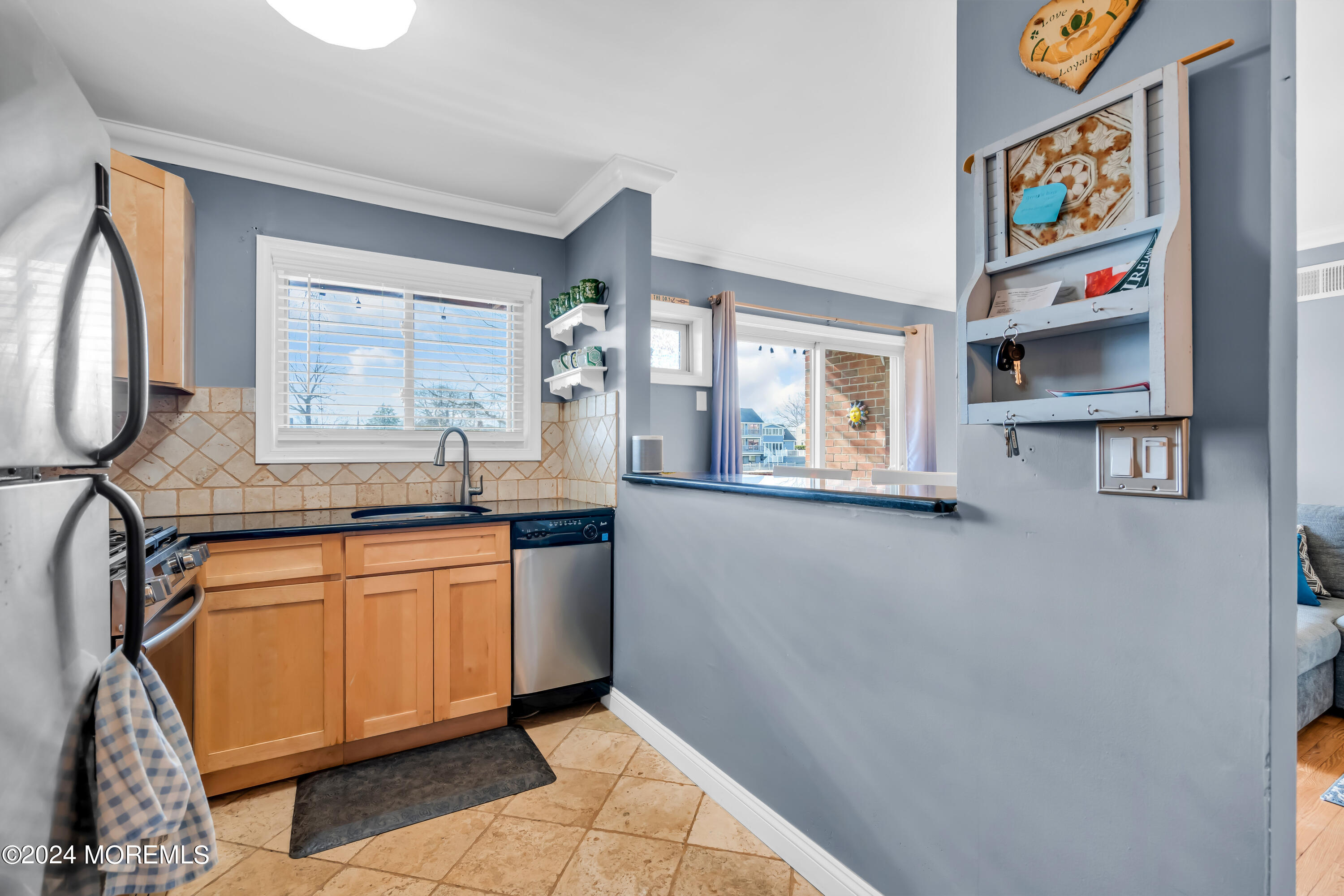 1641 Elm Avenue, Unit 18 Point Pleasant, NJ 08742 - Photo 9 of 23 a kitchen with stainless steel appliances granite countertop a sink and a refrigerator