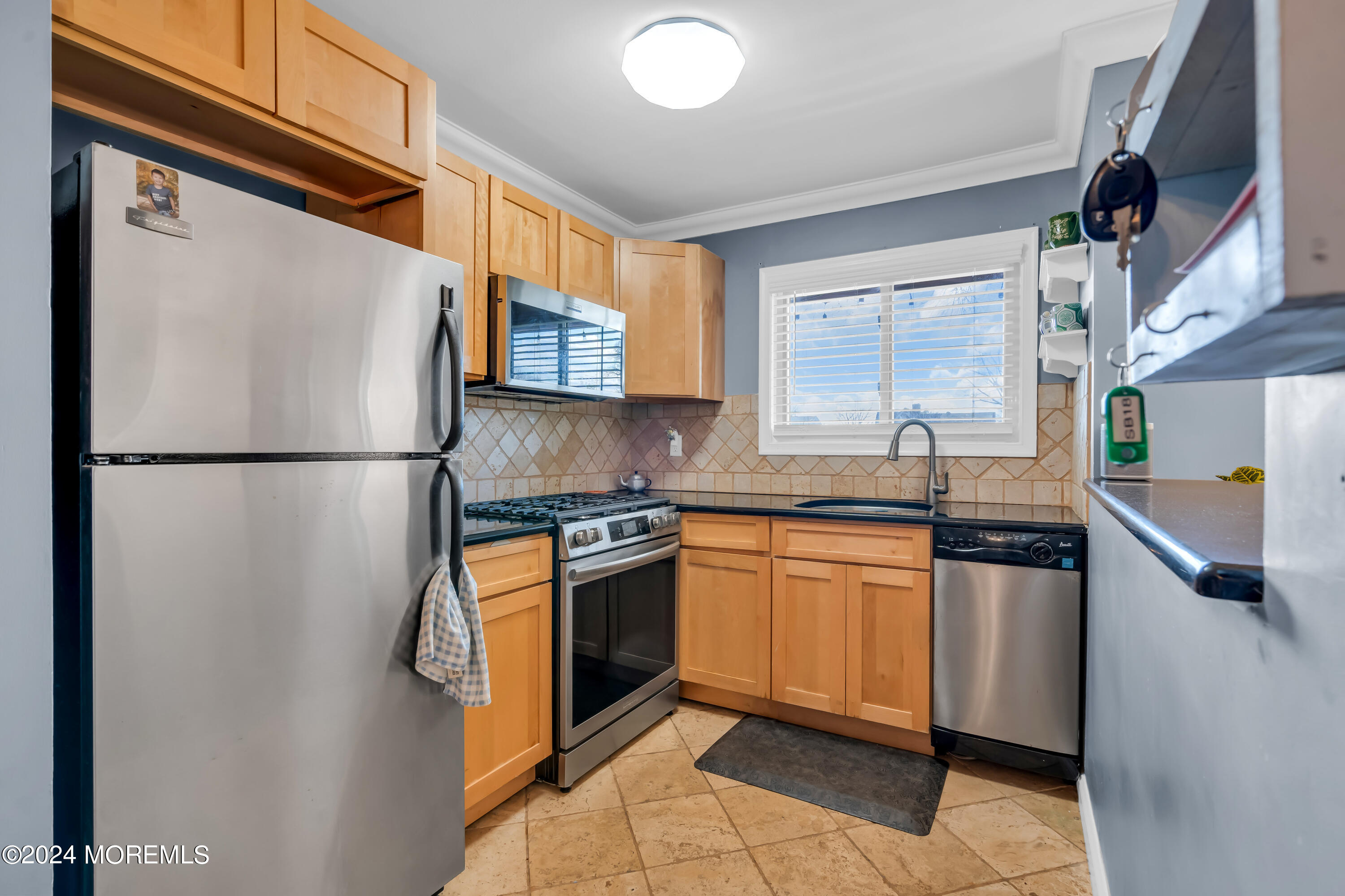 1641 Elm Avenue, Unit 18 Point Pleasant, NJ 08742 - Photo 10 of 23 a kitchen with stainless steel appliances granite countertop a refrigerator and a sink