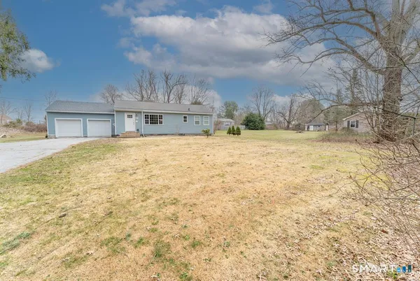 a view of house with yard and entertaining space
