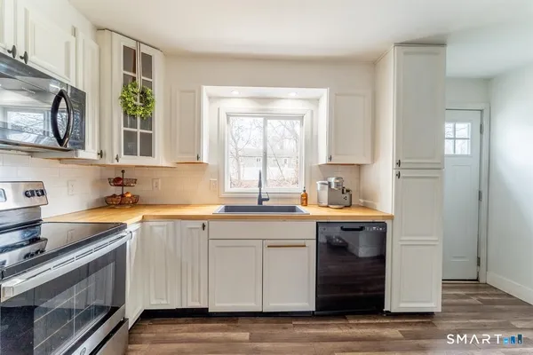 a kitchen with a sink stove and cabinets