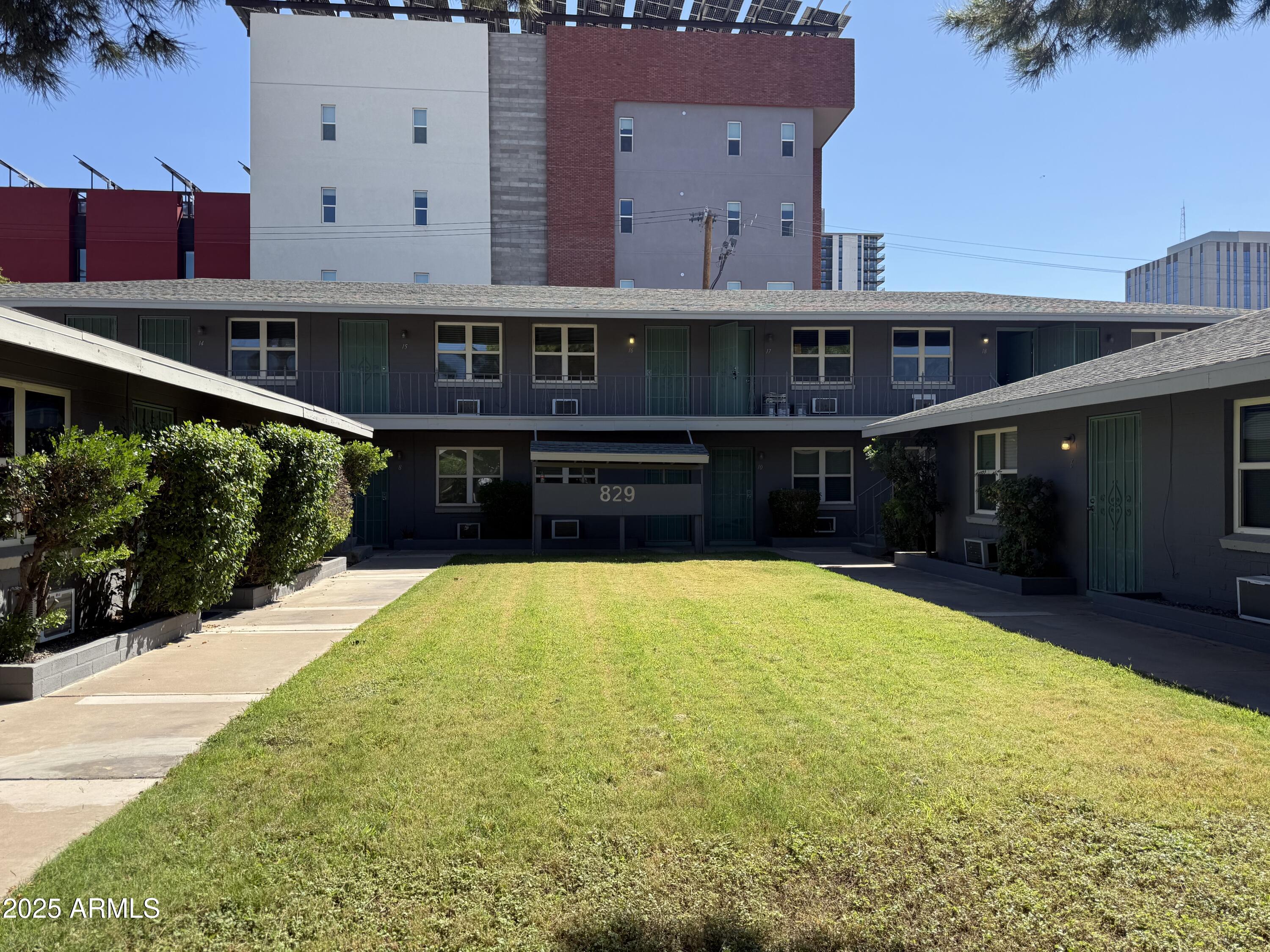 a front view of house with yard and trees in the background