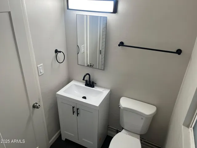 a white toilet sitting next to a bathroom sink