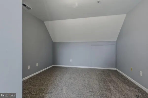 an empty room with furniture and a window