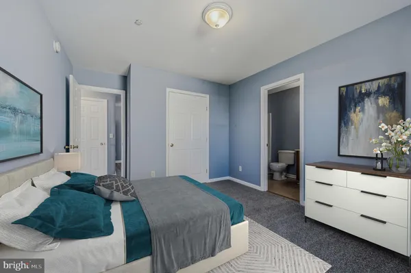a living room with furniture flat screen tv and wooden floor
