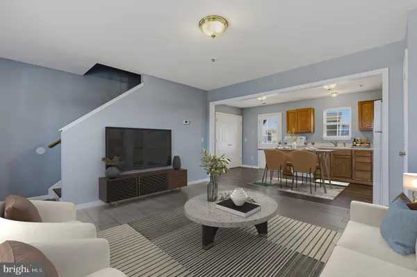 a kitchen with stainless steel appliances granite countertop a stove a sink a refrigerator a microwave oven with a dining table and chairs