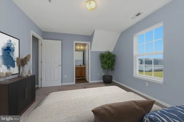 a bathroom with a granite countertop toilet sink and mirror