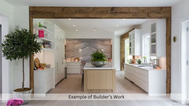 a living room with furniture and potted plant