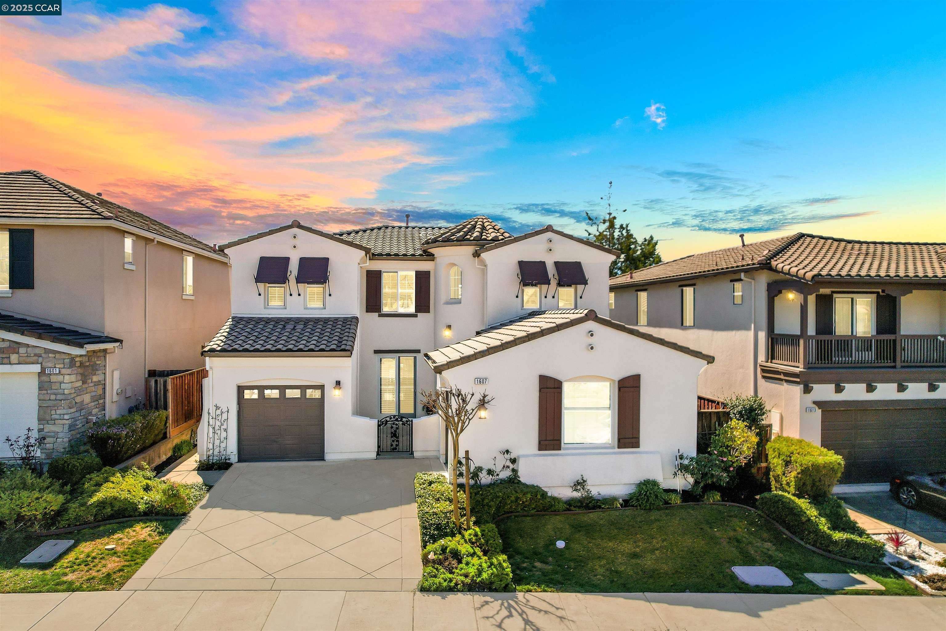 a front view of a house with a yard and garage