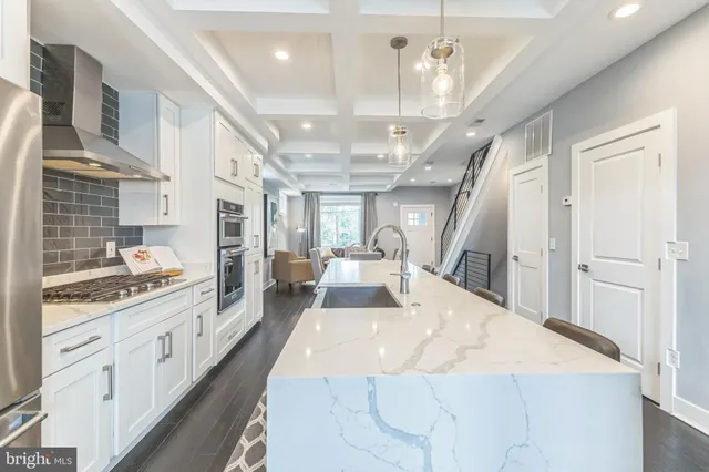 a large white kitchen with a large window