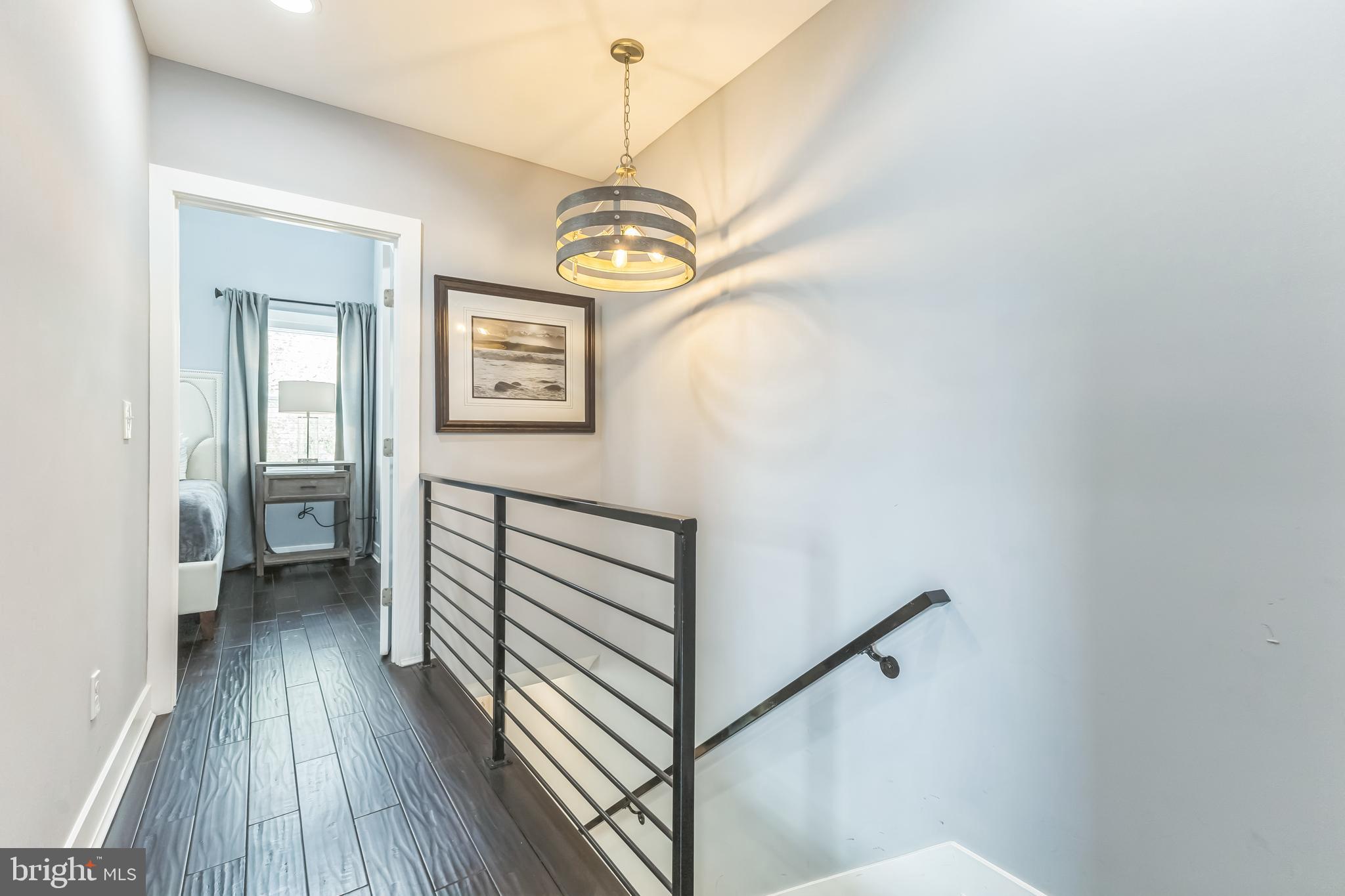 5623 Kansas Avenue Northwest Washington, DC 20011 - Photo 16 of 32 a view of a hallway with wooden floor and staircase