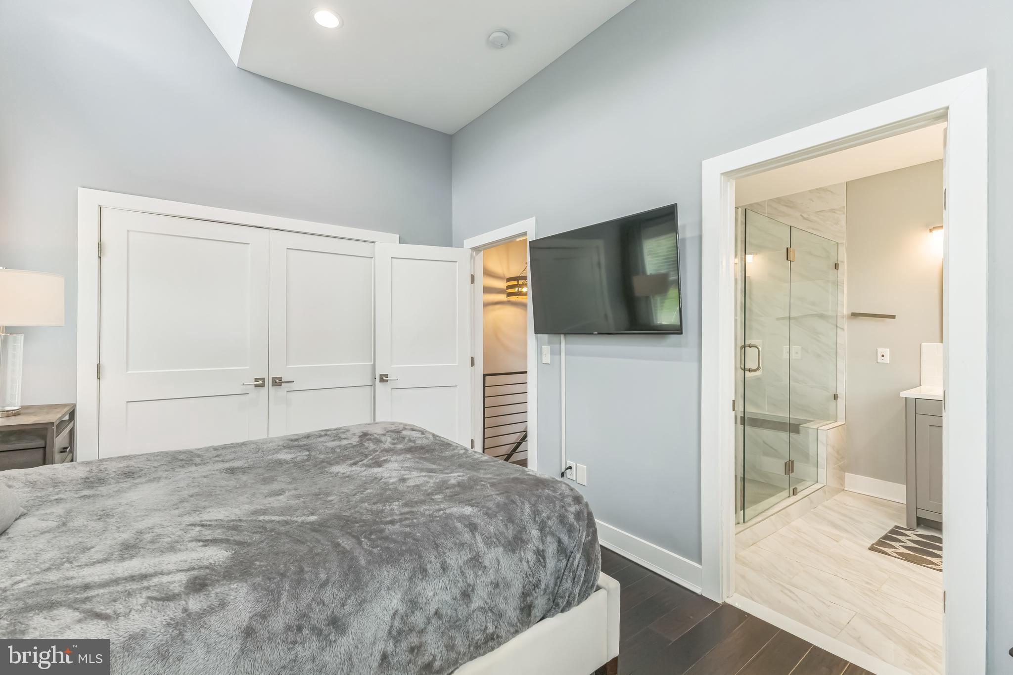 5623 Kansas Avenue Northwest Washington, DC 20011 - Photo 18 of 32 a bedroom with a bed and a bathroom