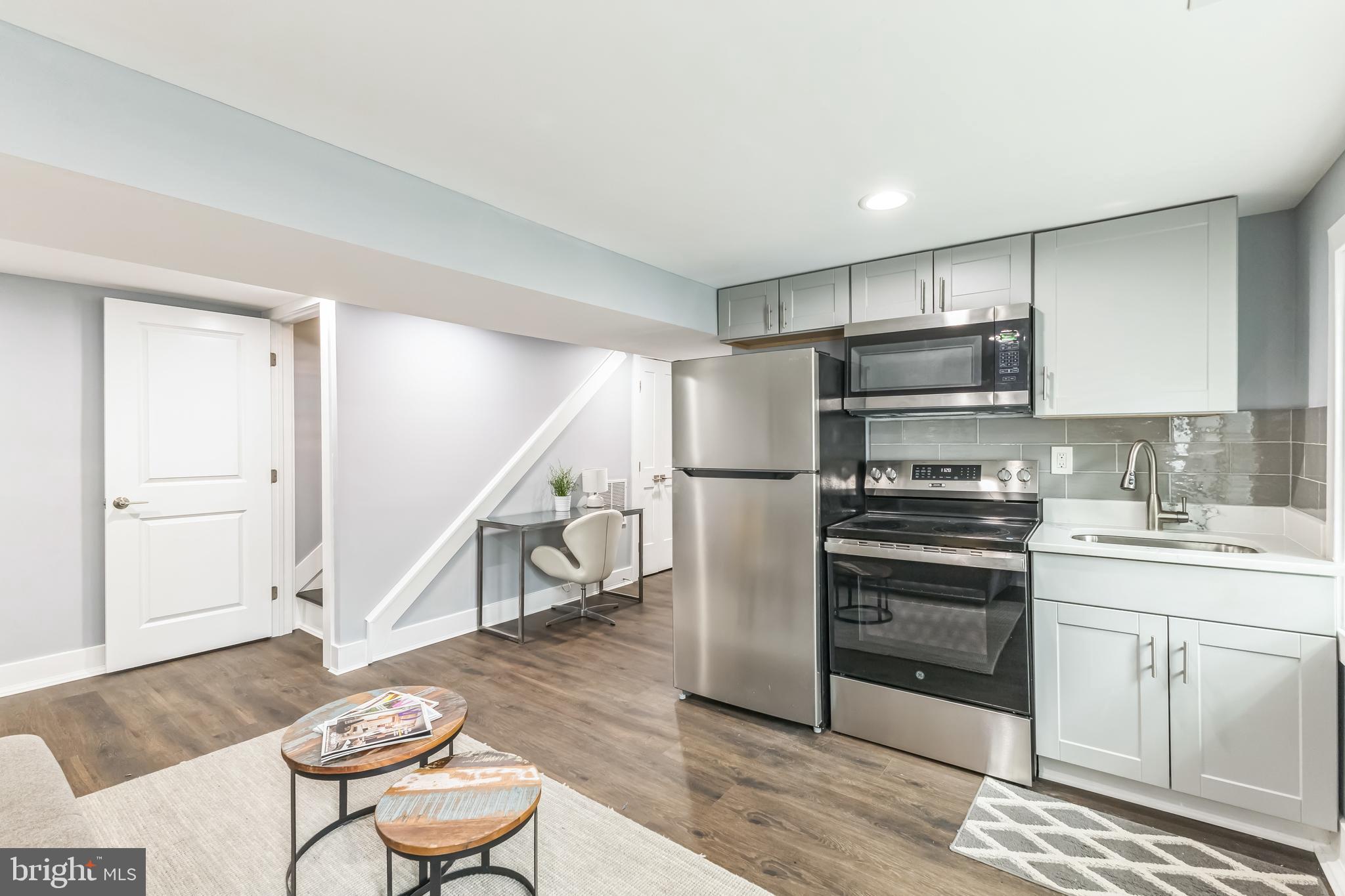 5623 Kansas Avenue Northwest Washington, DC 20011 - Photo 24 of 32 a kitchen with stainless steel appliances a refrigerator and wooden floor