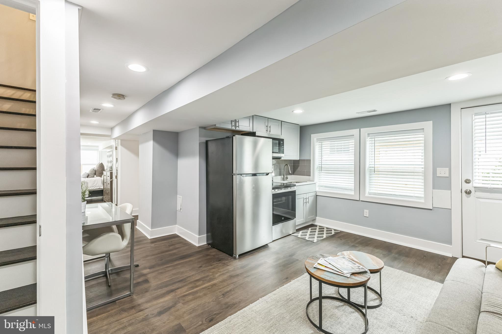 5623 Kansas Avenue Northwest Washington, DC 20011 - Photo 25 of 32 a kitchen with stainless steel appliances a refrigerator and wooden floor
