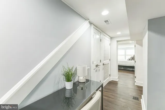 a hallway with wooden floor and furniture