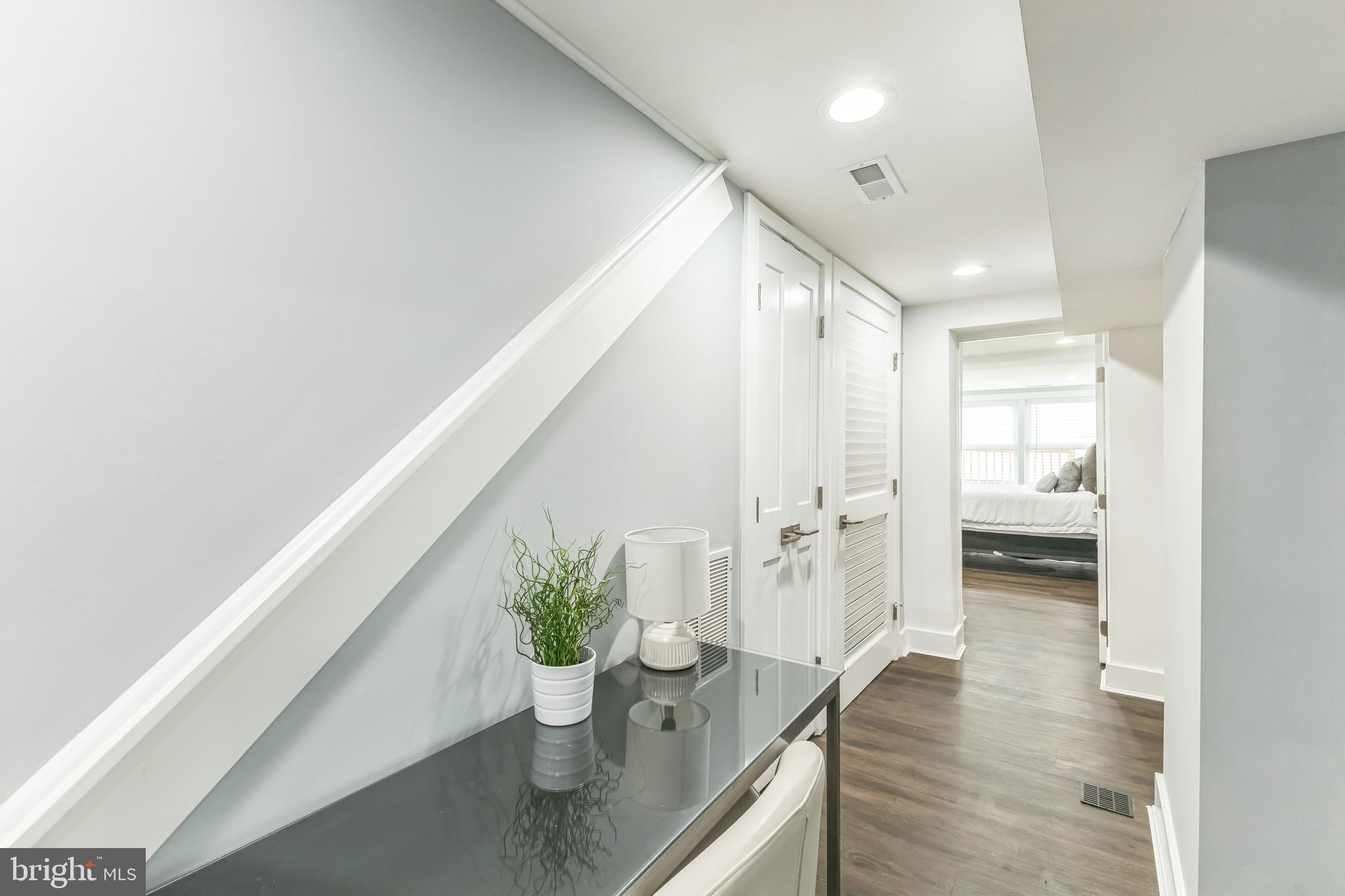 5623 Kansas Avenue Northwest Washington, DC 20011 - Photo 26 of 32 a hallway with wooden floor and furniture