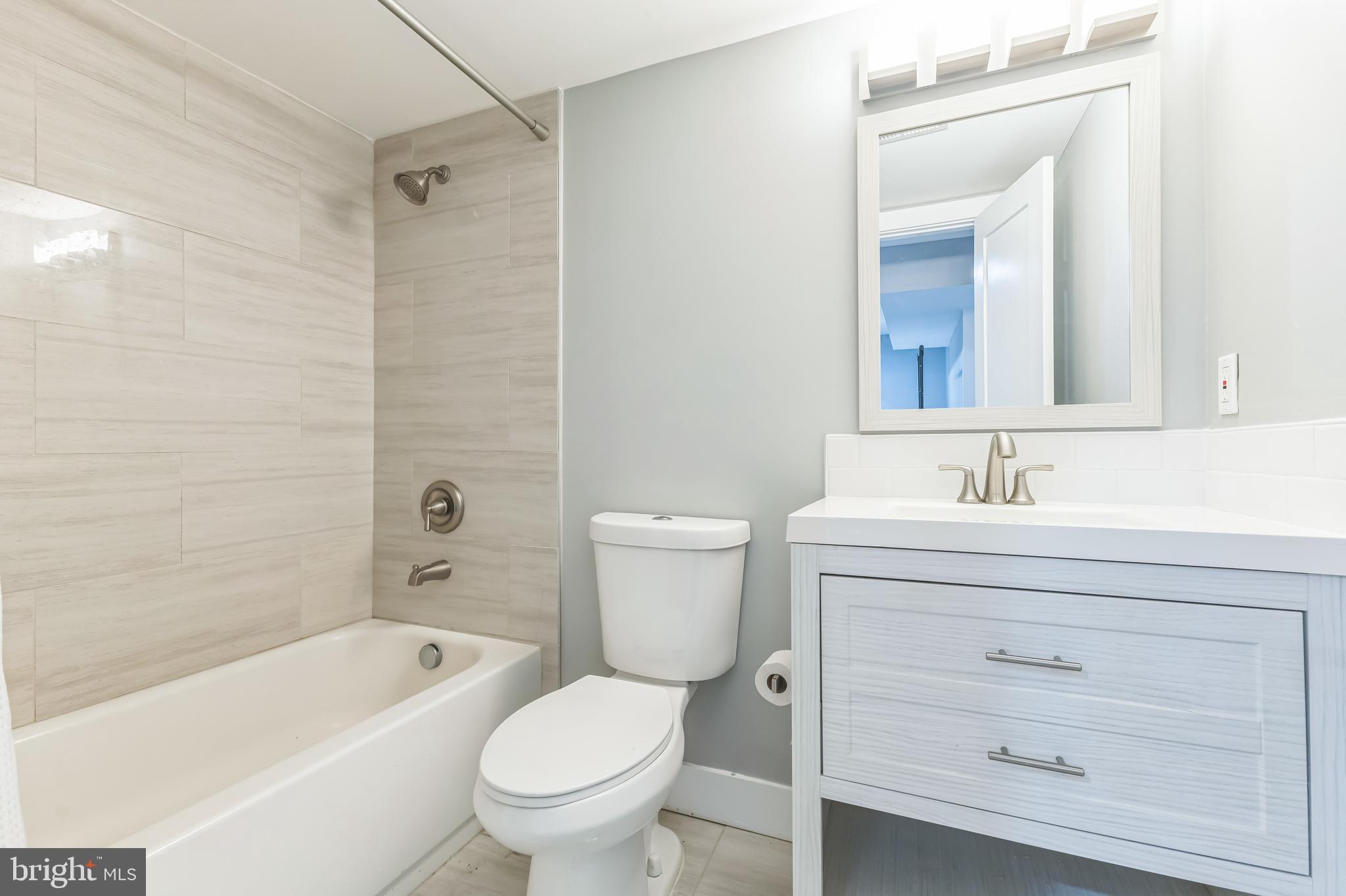 5623 Kansas Avenue Northwest Washington, DC 20011 - Photo 28 of 32 a bathroom with a sink a toilet and a bathtub