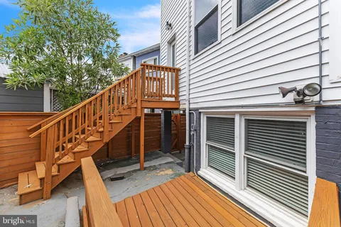 a view of entryway with wooden floor and fence