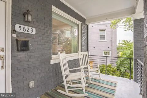 a view of a porch with a table and chairs